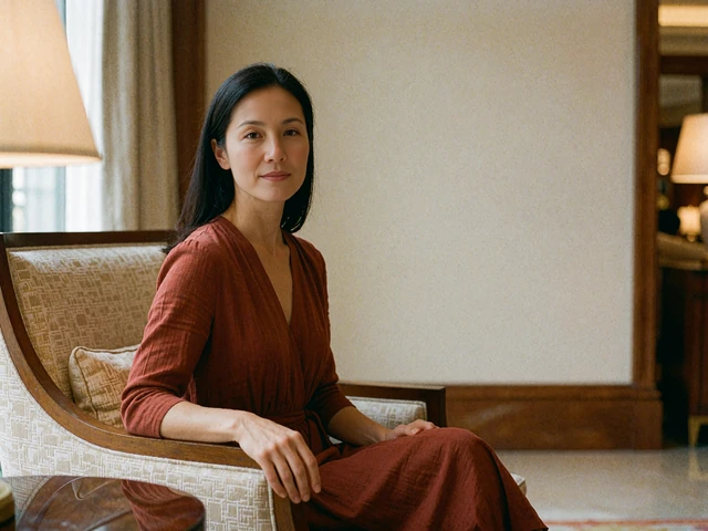 Woman in a rust dress seated calmly in an upscale hotel lobby armchair, waiting for a first meeting